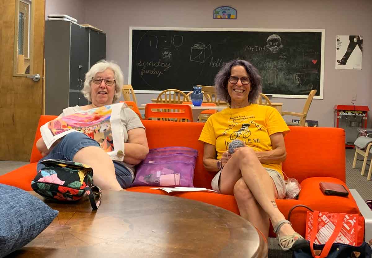 Two Women - one knitting, one doing needlepoint